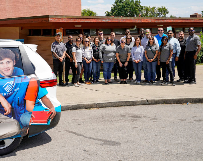 bridgestone team standing behind back2school van