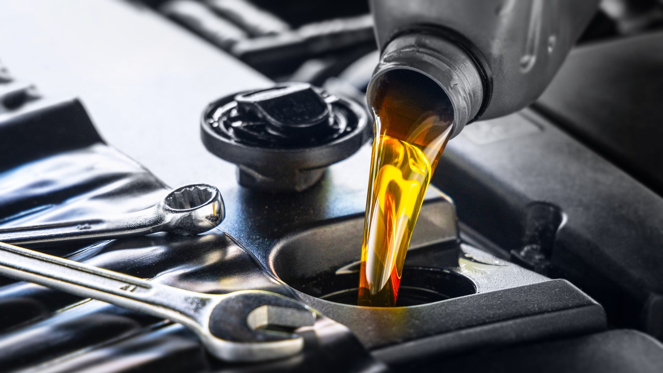 image of oil being poured into an engine