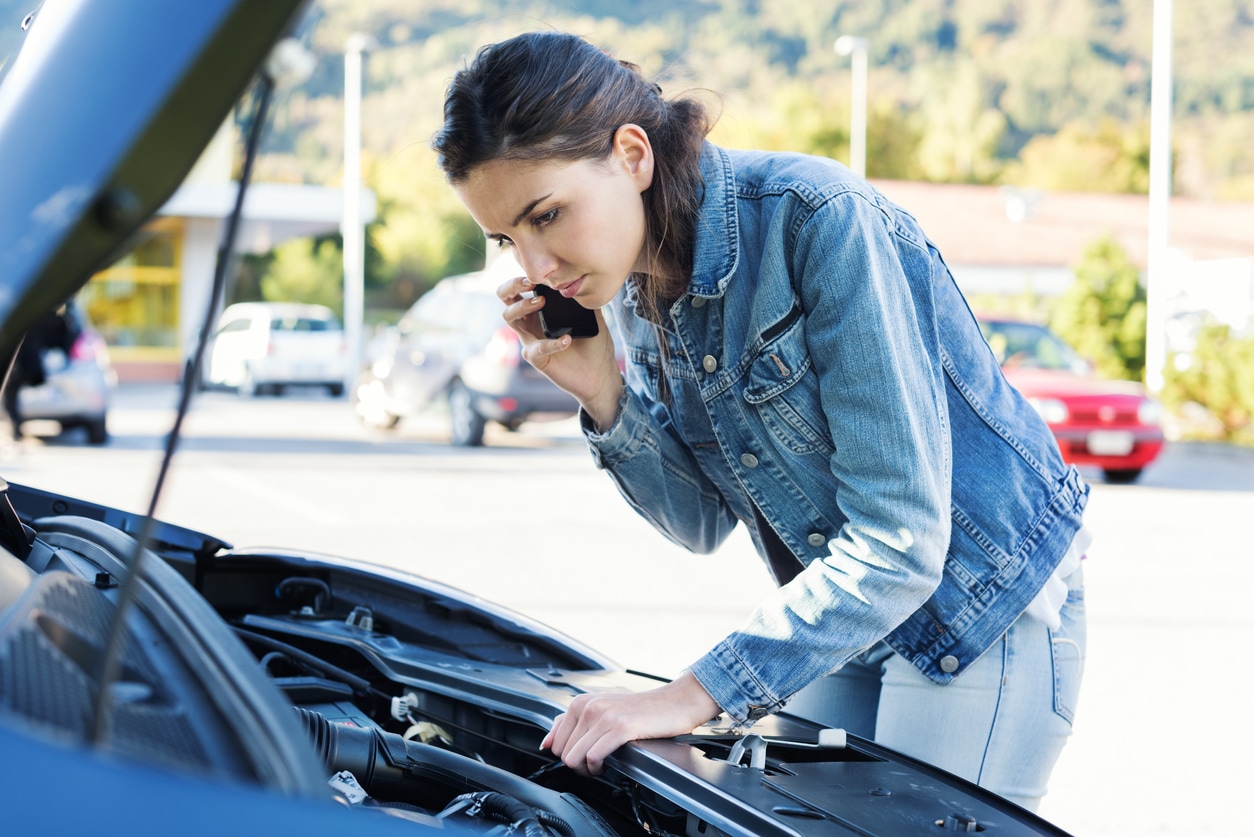 image of woman calling car assistance